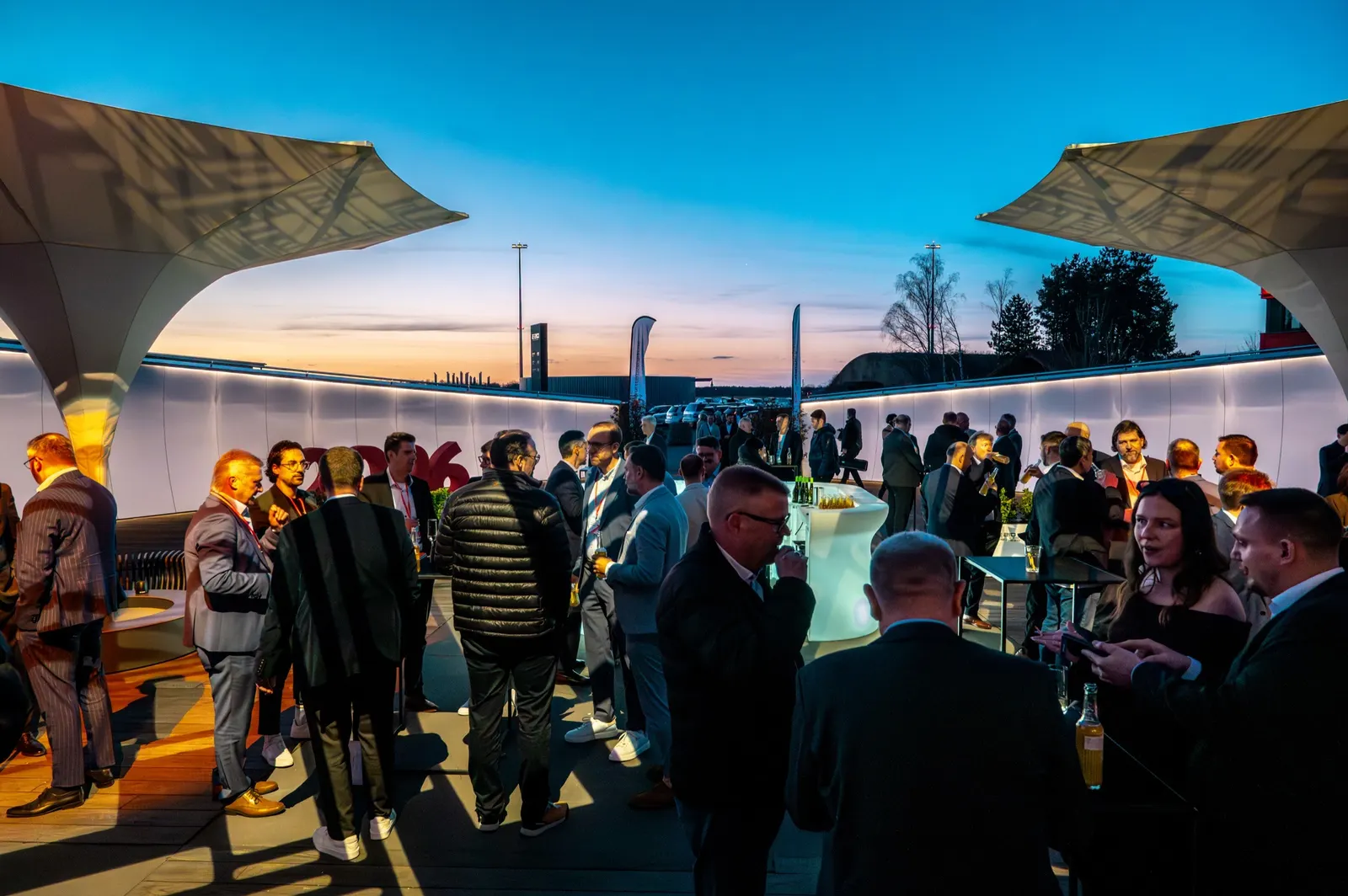 Gäste im Gespräch auf der Terrasse bei Sonnenuntergang